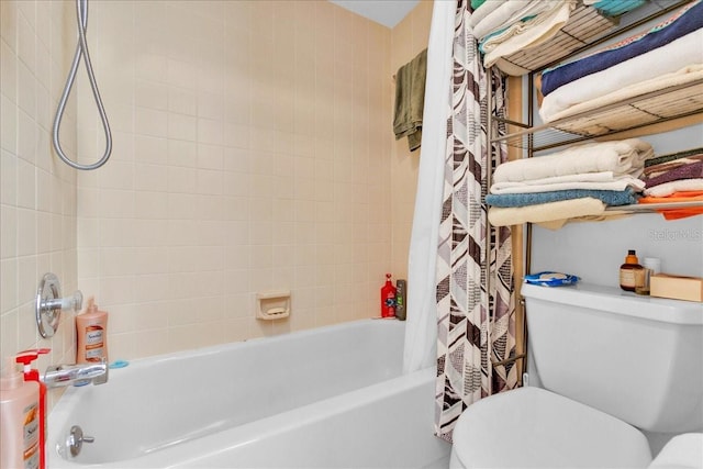 bathroom featuring shower / tub combo and toilet