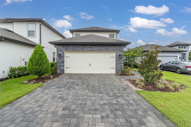 view of front of house featuring a garage and a front lawn