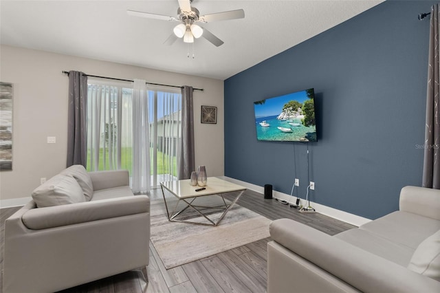 living room with ceiling fan and wood-type flooring