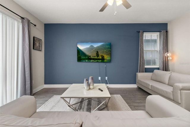 living room featuring ceiling fan and hardwood / wood-style flooring