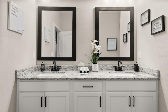 bathroom with dual bowl vanity