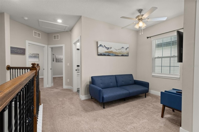 living area featuring ceiling fan and light carpet