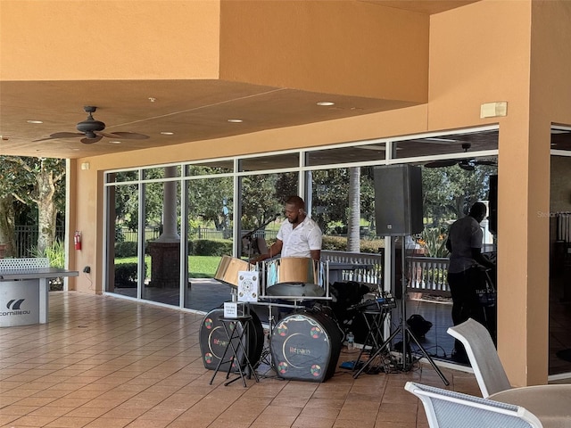 exterior space with ceiling fan