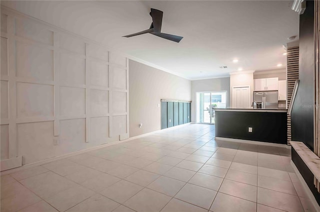 tiled spare room with ceiling fan and crown molding