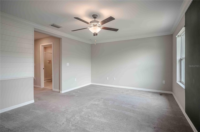 unfurnished room with ceiling fan, ornamental molding, and carpet