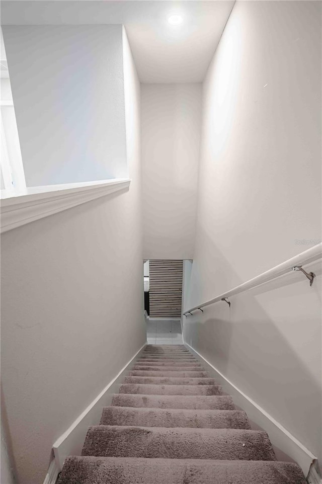 stairway featuring tile patterned floors