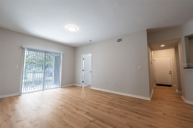 spare room featuring light wood-type flooring