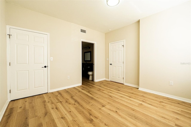 interior space featuring ensuite bathroom and light wood-type flooring