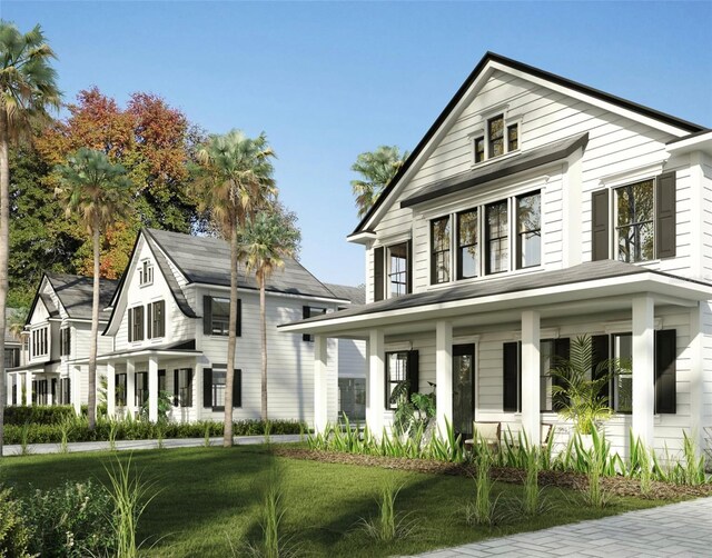 view of front of property with covered porch and a front yard