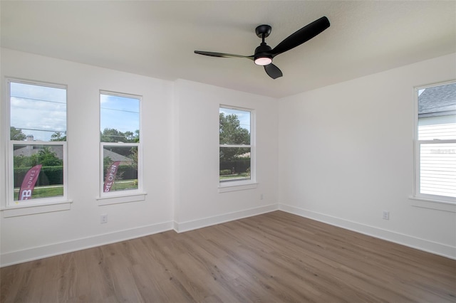 spare room featuring hardwood / wood-style flooring and ceiling fan