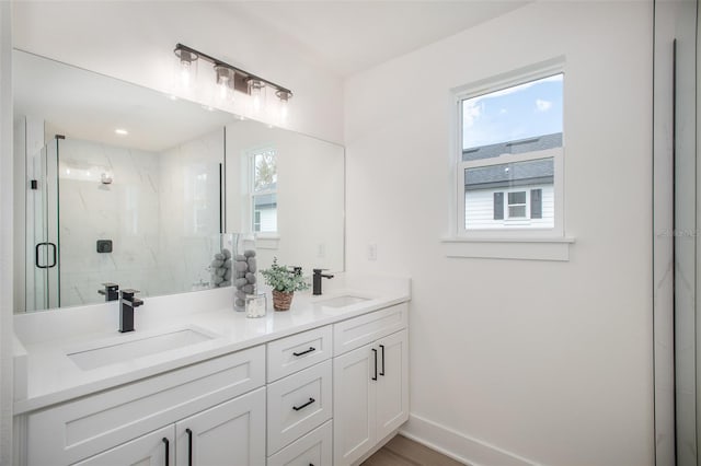 bathroom featuring vanity, an enclosed shower, and hardwood / wood-style flooring