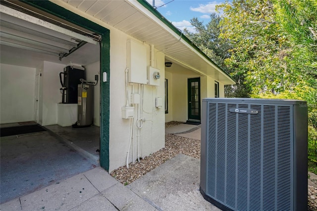 exterior space featuring cooling unit, a patio area, and water heater