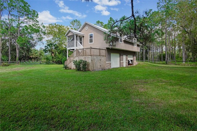 view of side of property with a sunroom and a lawn