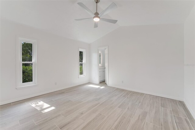 unfurnished room with lofted ceiling, light hardwood / wood-style flooring, and ceiling fan