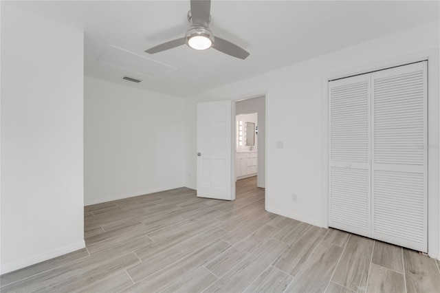 unfurnished bedroom featuring ceiling fan, a closet, and light wood-type flooring