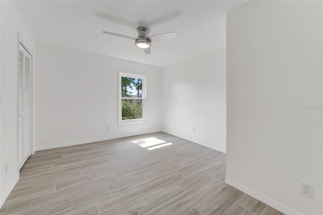 unfurnished room with ceiling fan and light wood-type flooring