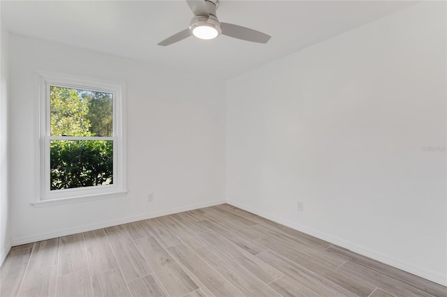 empty room with ceiling fan and light hardwood / wood-style floors