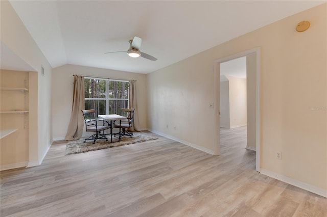 unfurnished dining area with light hardwood / wood-style flooring, ceiling fan, and vaulted ceiling