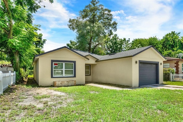 single story home with a front yard and a garage