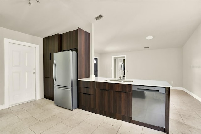 kitchen with dark brown cabinets, light tile patterned floors, sink, and stainless steel appliances