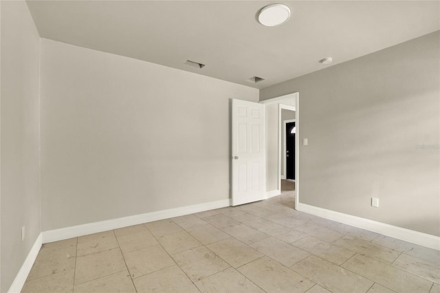 unfurnished room featuring light tile patterned flooring