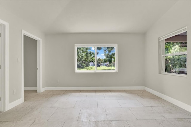 tiled empty room with a healthy amount of sunlight