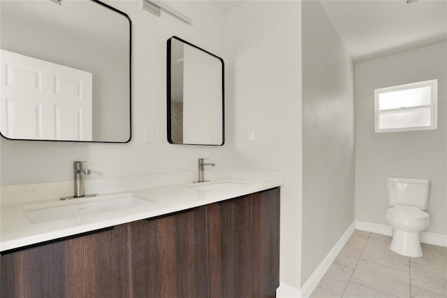 bathroom featuring double sink vanity, toilet, and tile patterned floors