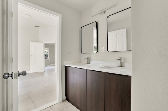 bathroom with dual vanity and tile patterned flooring