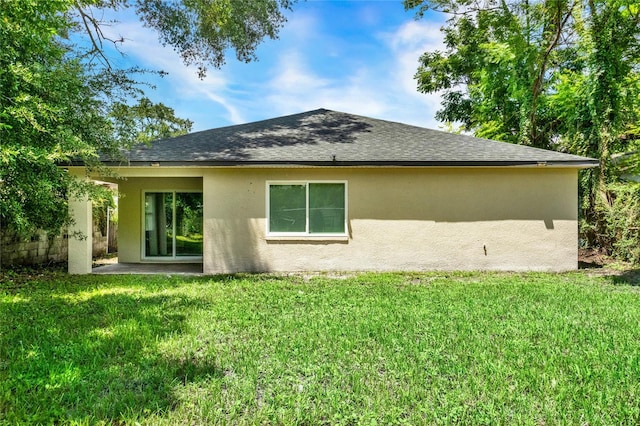 back of house with a yard