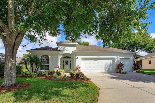 view of front of home with a front yard and a garage