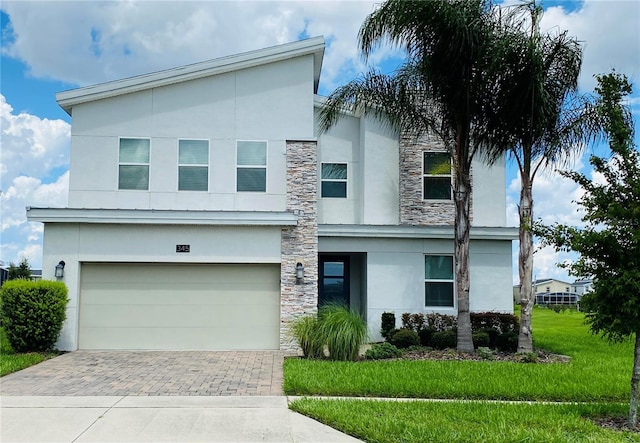 contemporary house with a garage and a front lawn