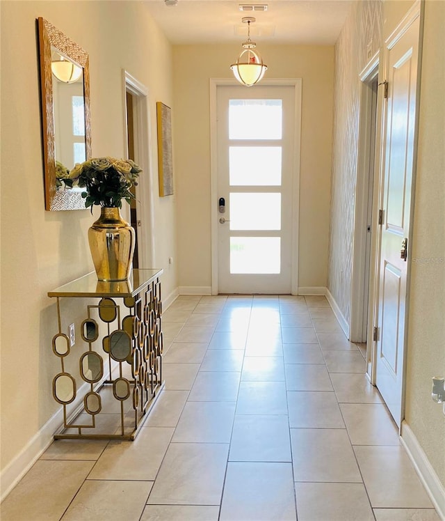 entryway with light tile patterned flooring