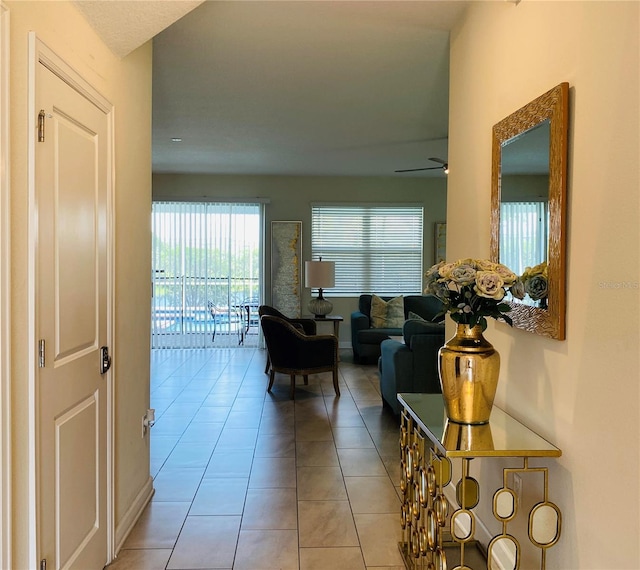 hall featuring light tile patterned flooring