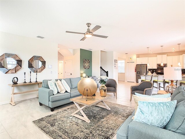 living room featuring ceiling fan and light tile patterned floors