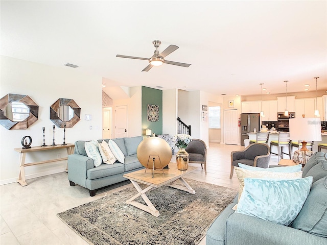 living room featuring light tile patterned floors and ceiling fan