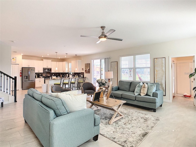 living room featuring ceiling fan and light tile patterned floors