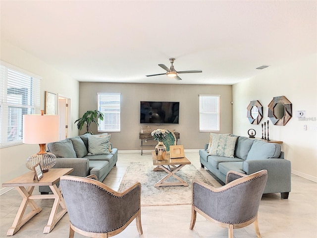 living room featuring ceiling fan and plenty of natural light