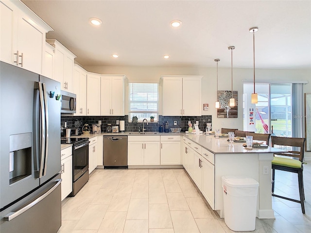 kitchen featuring light tile patterned floors, backsplash, stainless steel appliances, and pendant lighting