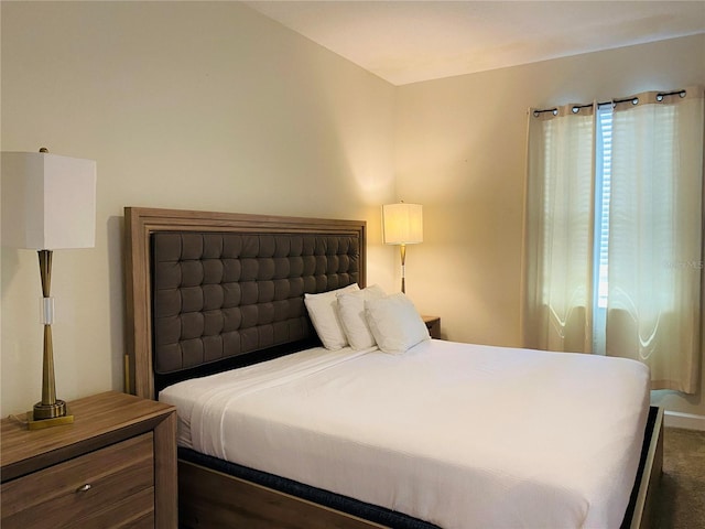 carpeted bedroom featuring multiple windows