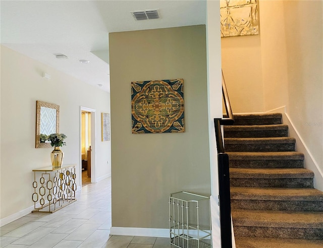 stairway with light tile patterned flooring