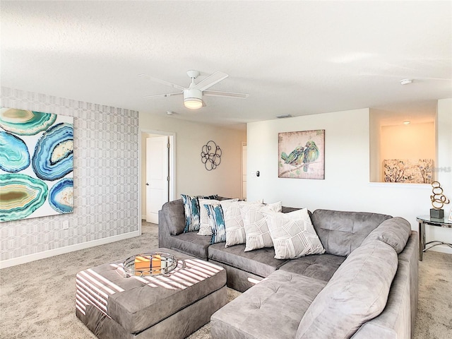 carpeted living room with ceiling fan and a textured ceiling