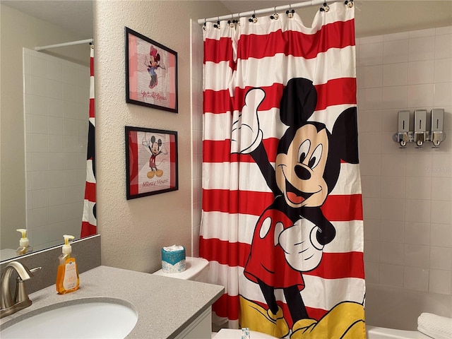 full bathroom featuring shower / bath combination with curtain, vanity, and toilet