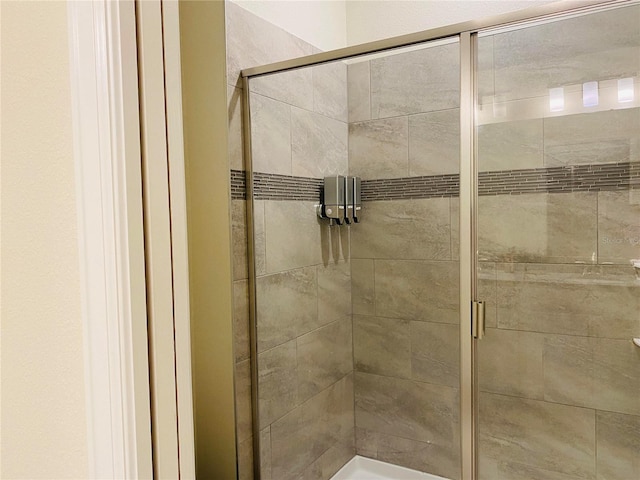 bathroom with a shower with door