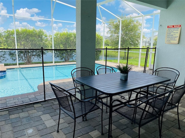 view of swimming pool featuring a patio and a lanai