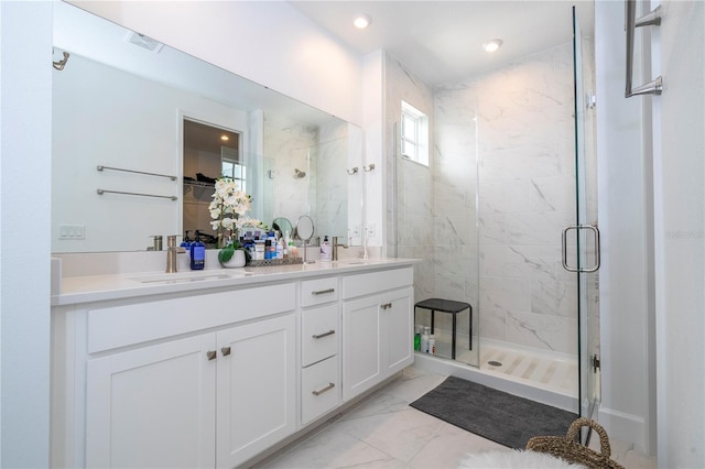 bathroom featuring a shower with door, vanity, and tile patterned flooring