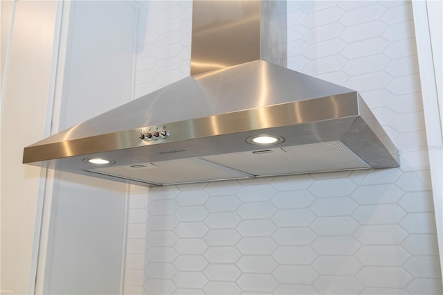 details featuring wall chimney exhaust hood