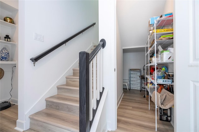 stairway with hardwood / wood-style flooring