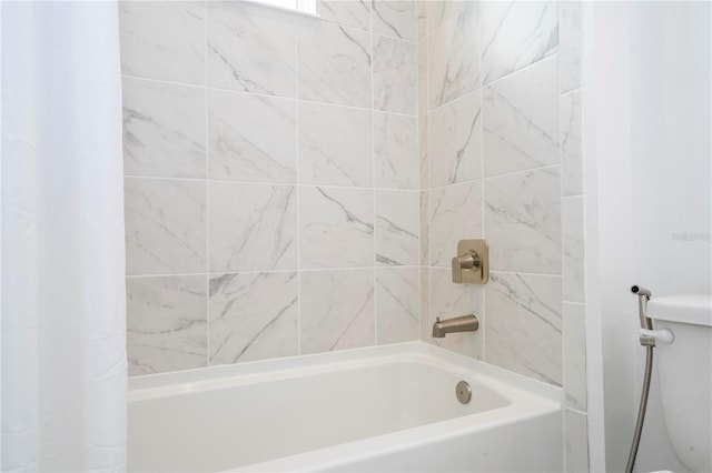 bathroom with shower / bath combo with shower curtain and toilet