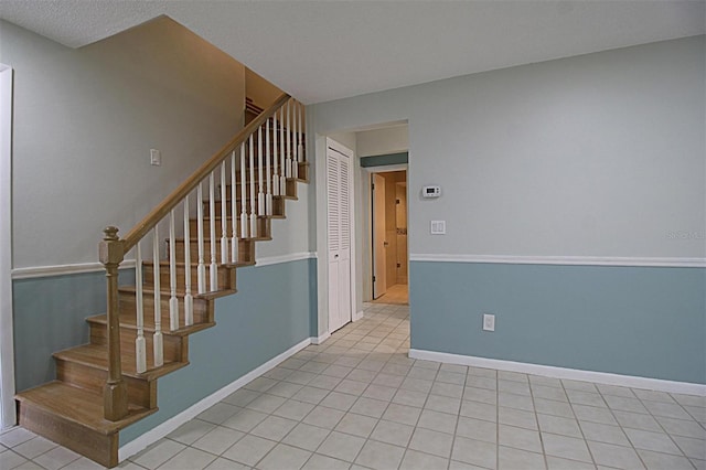 stairs with tile patterned flooring