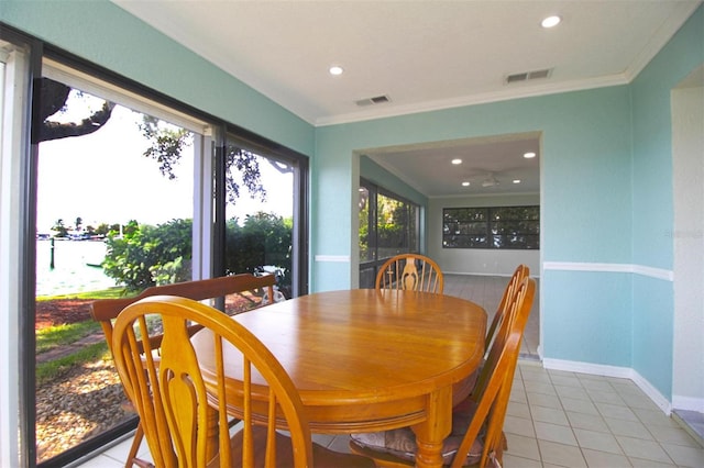 dining space featuring tile patterned flooring and crown molding